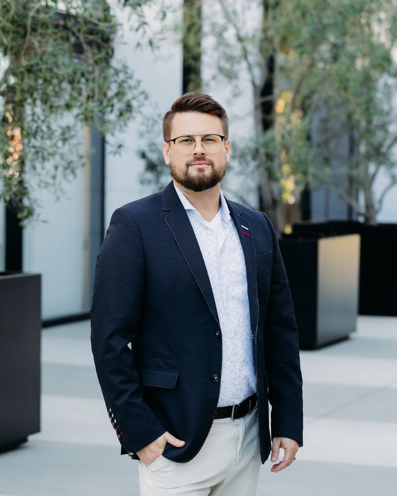 Colin Rickard standing in a courtyard